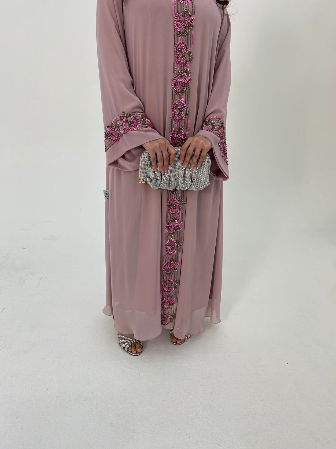 Mauve abaya with floral embroidery on a white background