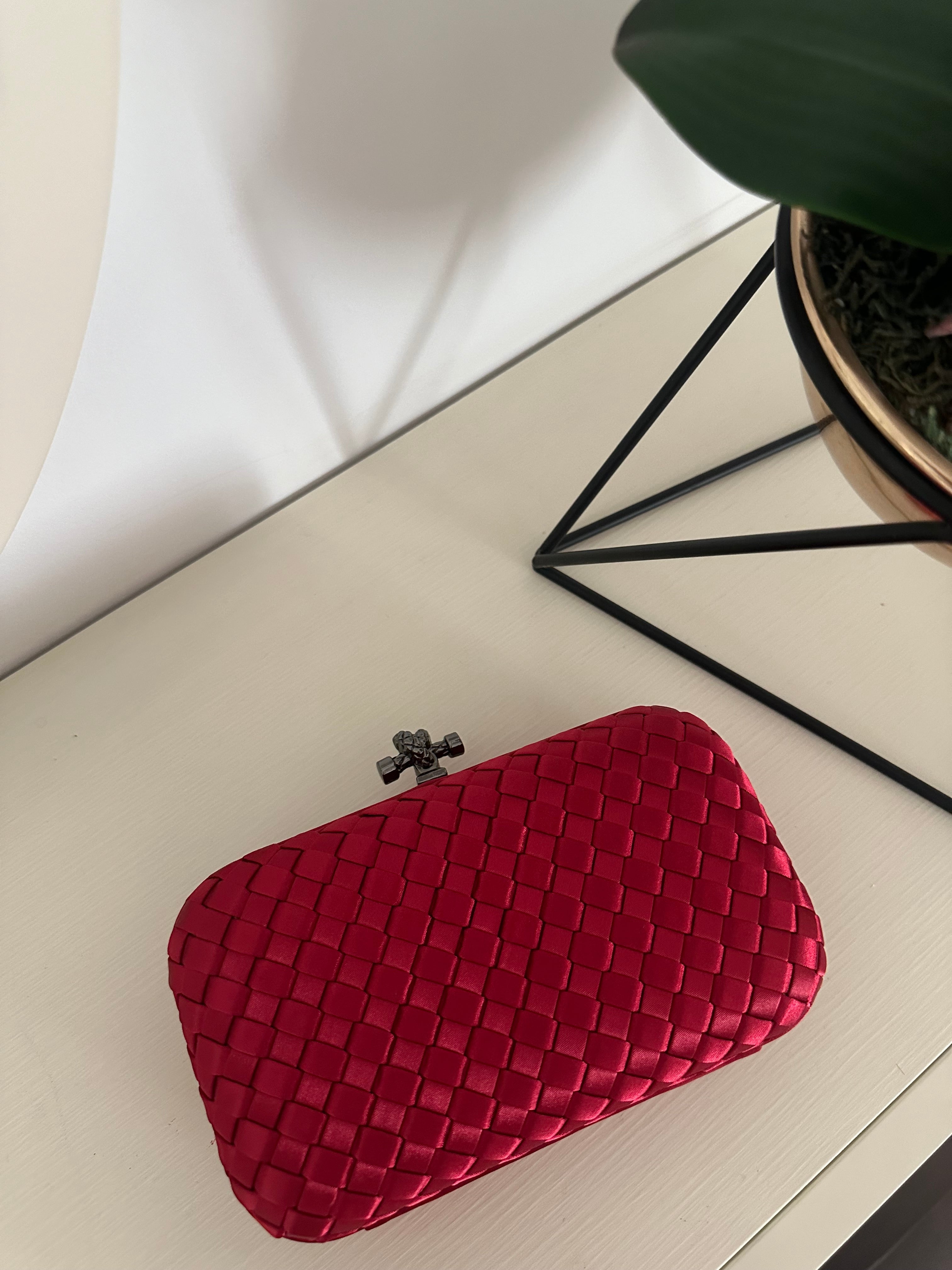 Clear UAE red mini clutch bag front view

