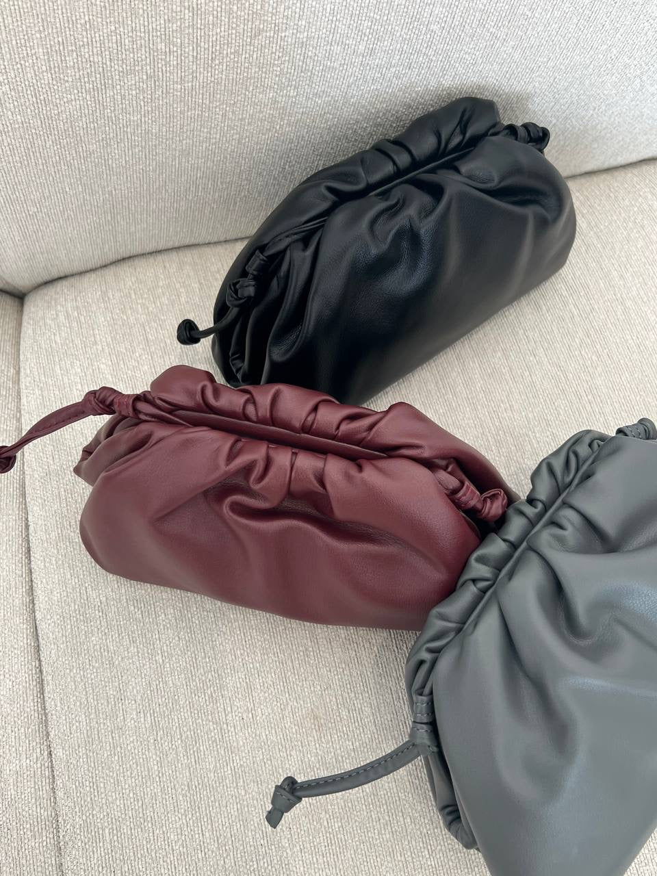 Clear UAE maroon Bottega pouch bag detail view
