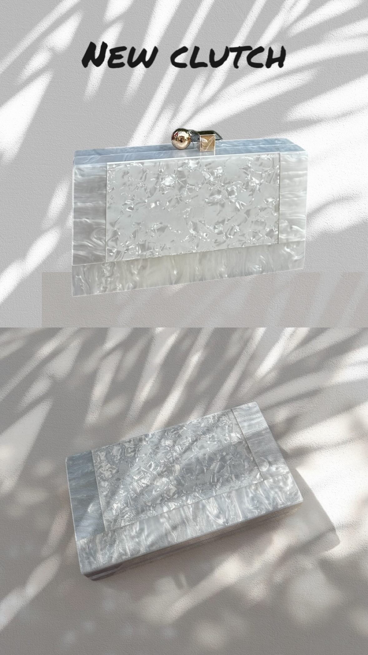 Silver clutch bag with a textured surface on a light background