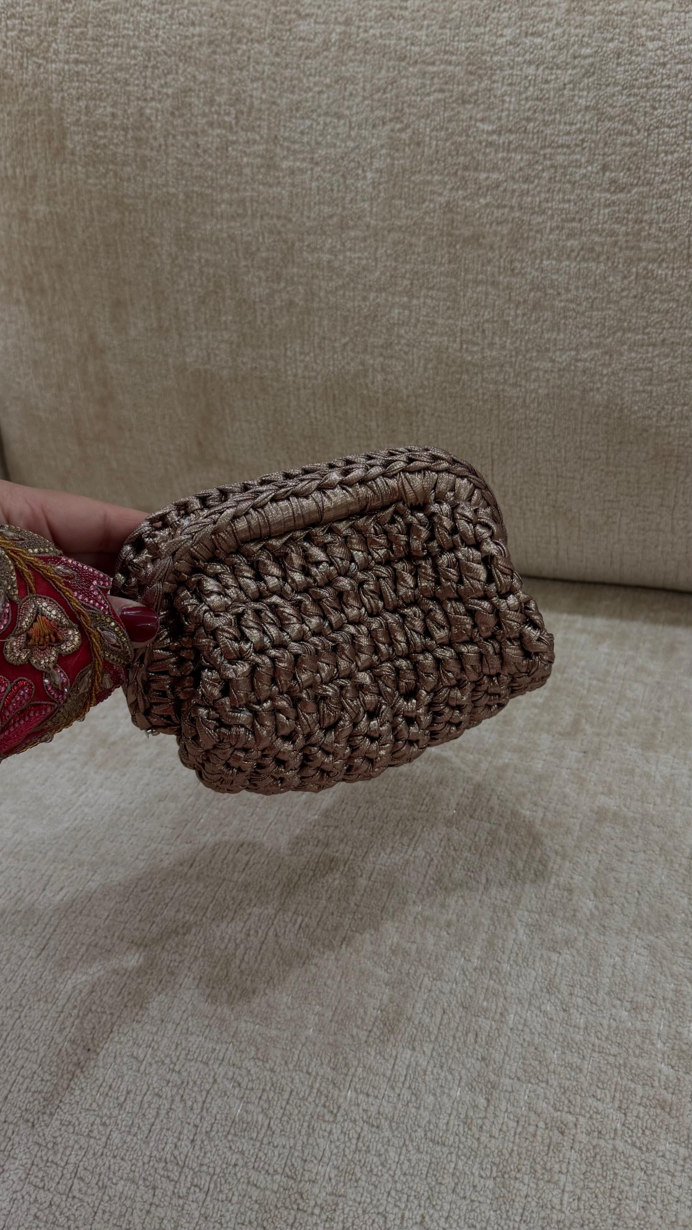 Handheld woven basket on a beige surface