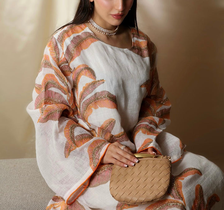 A person holding a beige mini bag with a textured surface.