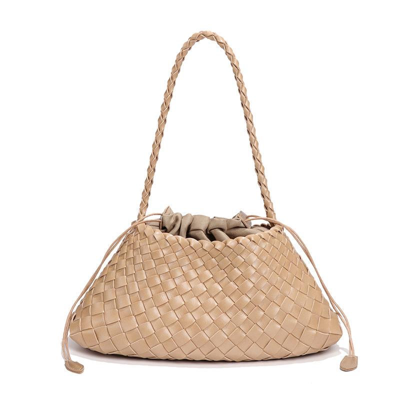 Beige woven handbag with braided handle on a white background