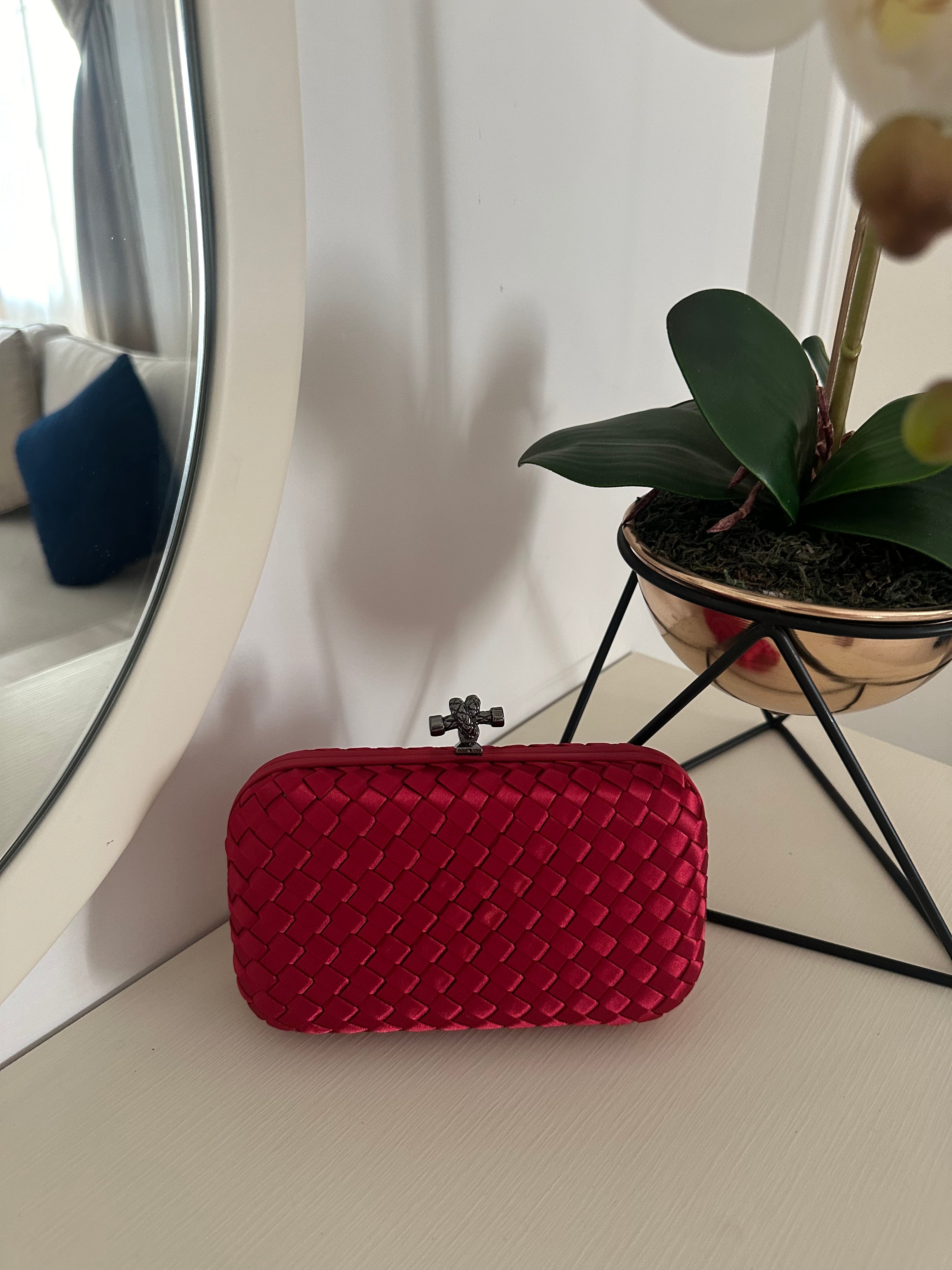 Clear UAE red mini clutch bag front view
