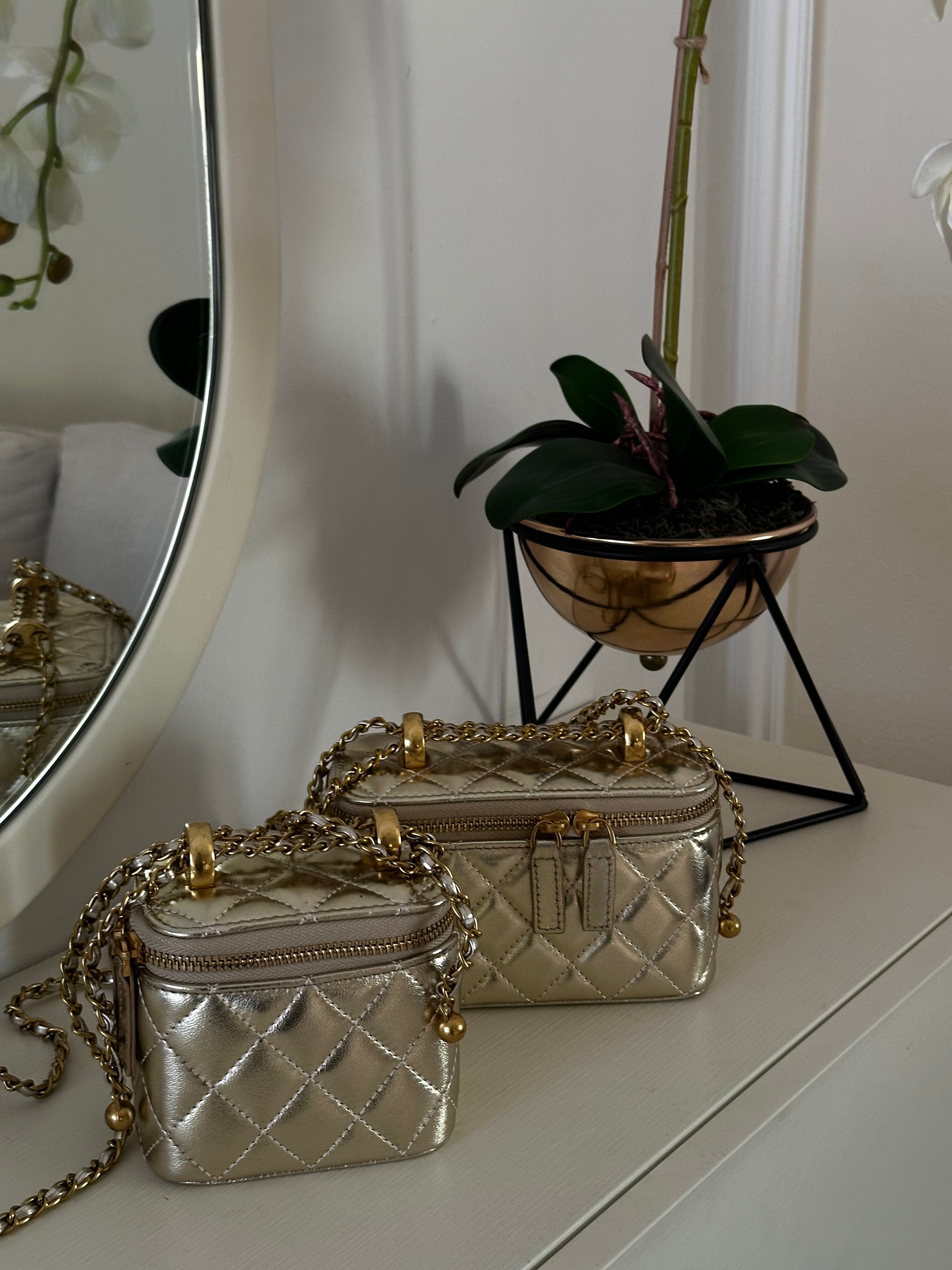 Metallic handbag with chain strap on a marble surface