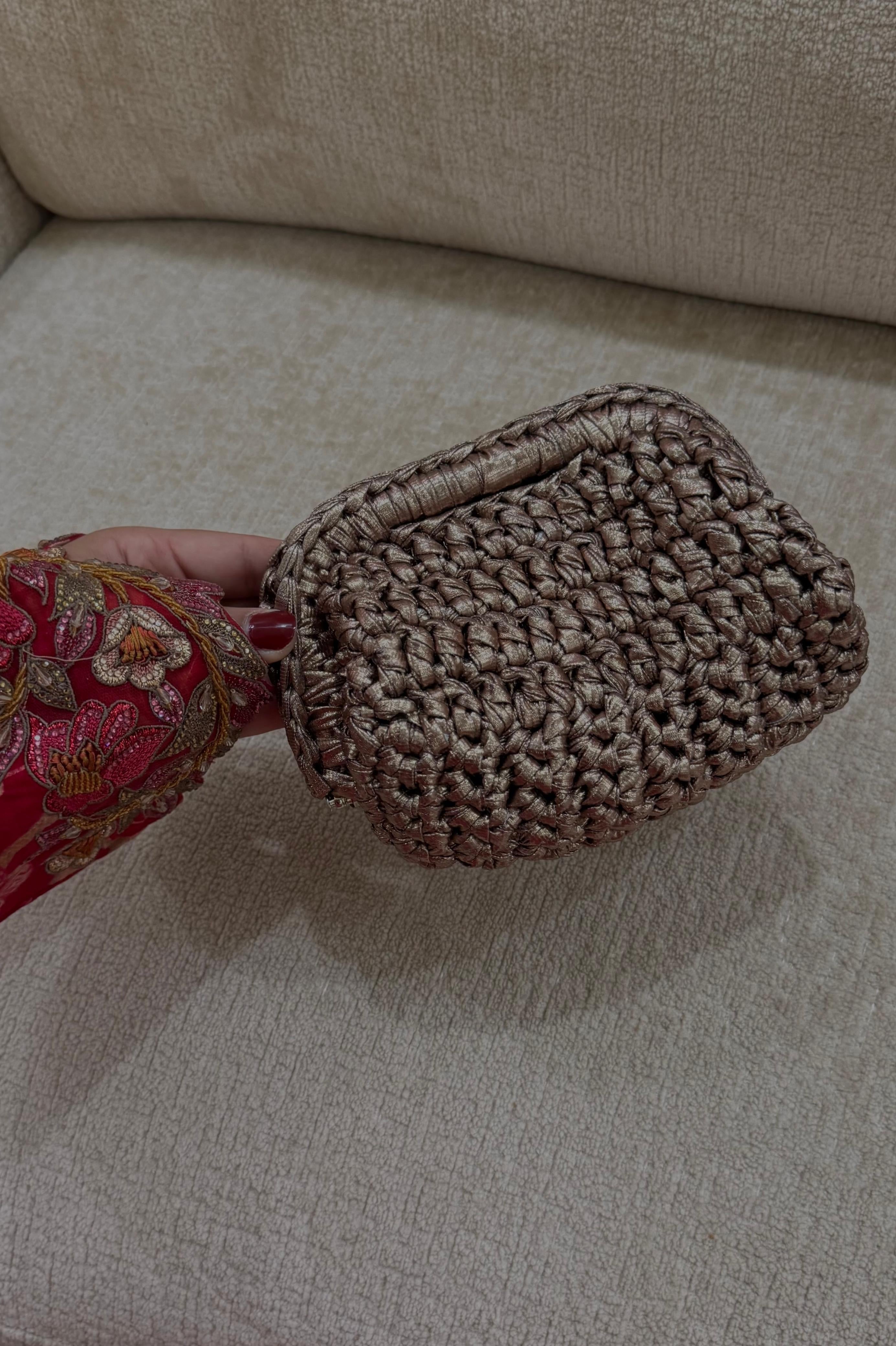 Textured brown clutch on a beige sofa