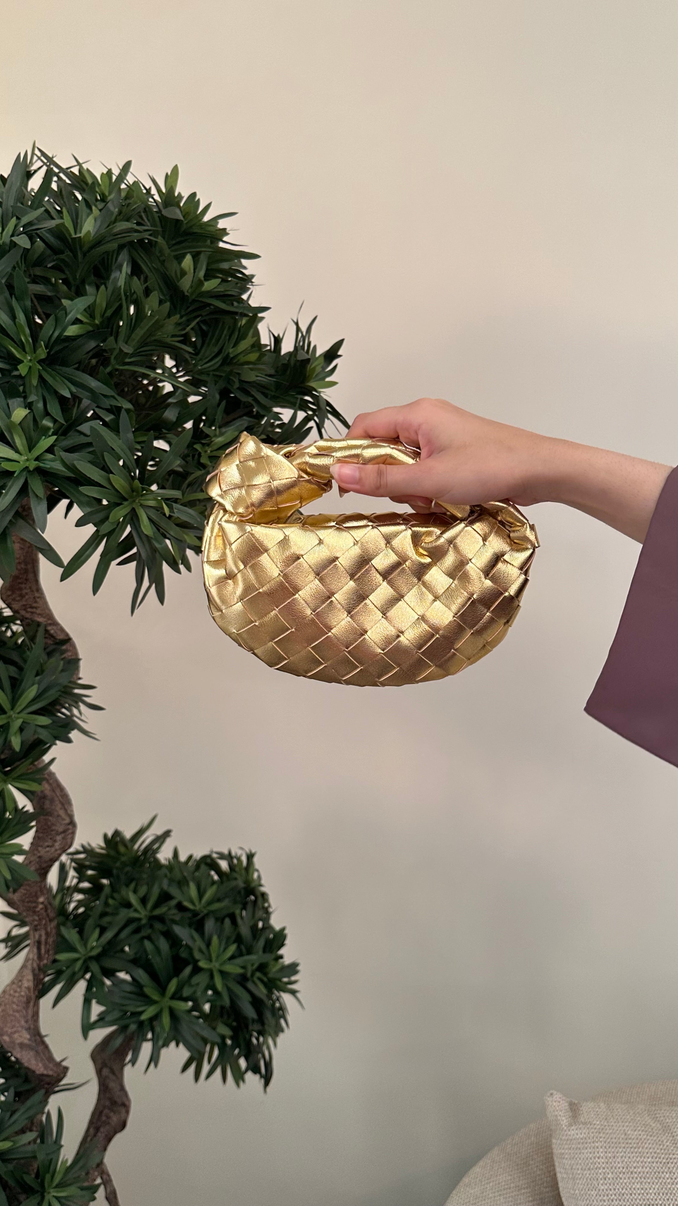 Gold micro handle bag by Clear UAE
