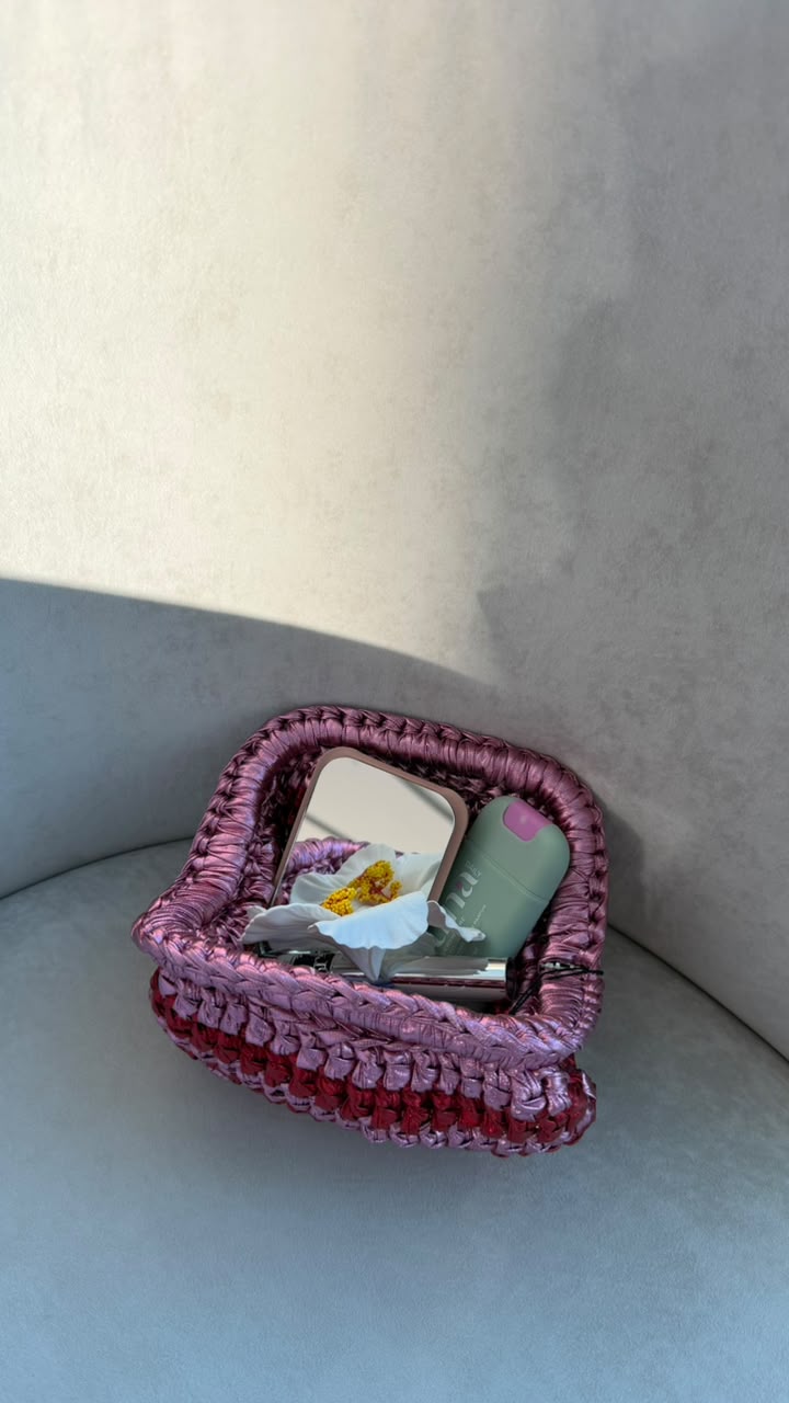 Mix Pink Red Bag lifestyle shot with model holding lipstick