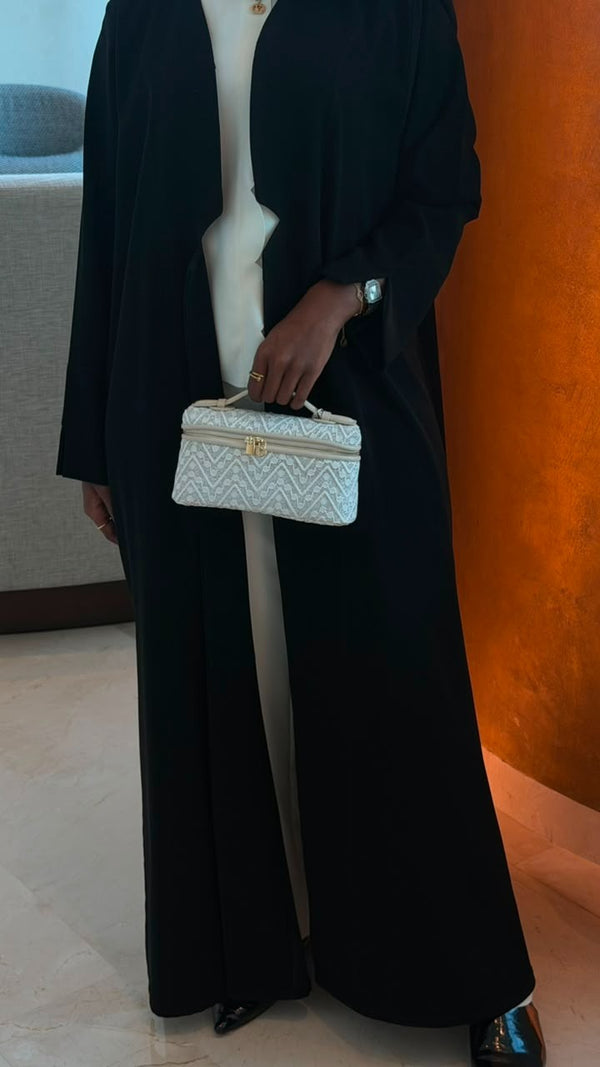 Quilted Chevron Vanity Bag in White – front view held by model