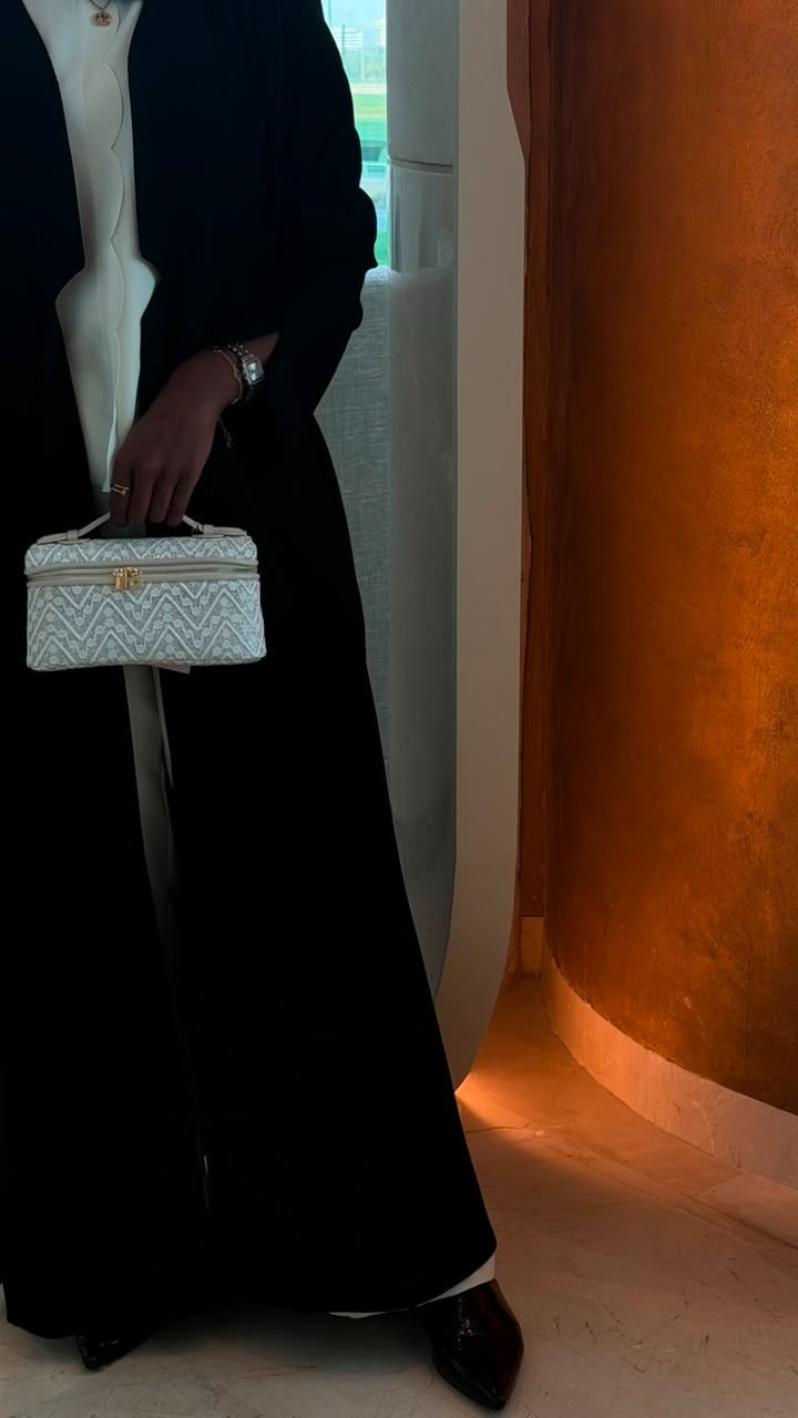 Quilted Chevron Vanity Bag in White – side view held by model